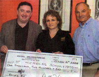 Tracey Fitzgerald and Billy Higgins presenting a cheque, from the Adare Holy Trinity Abbey Choir tour of the USA to Rev Alan Matchett