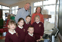Marion Tobin, principal, Southill Junior School and second class pupils Sophie Bannon, Dion Moore, Daniel Joyce, Hazel Moore and Mark Crawford showing their computer skills to Billy Higgins during his recent visit to the school.